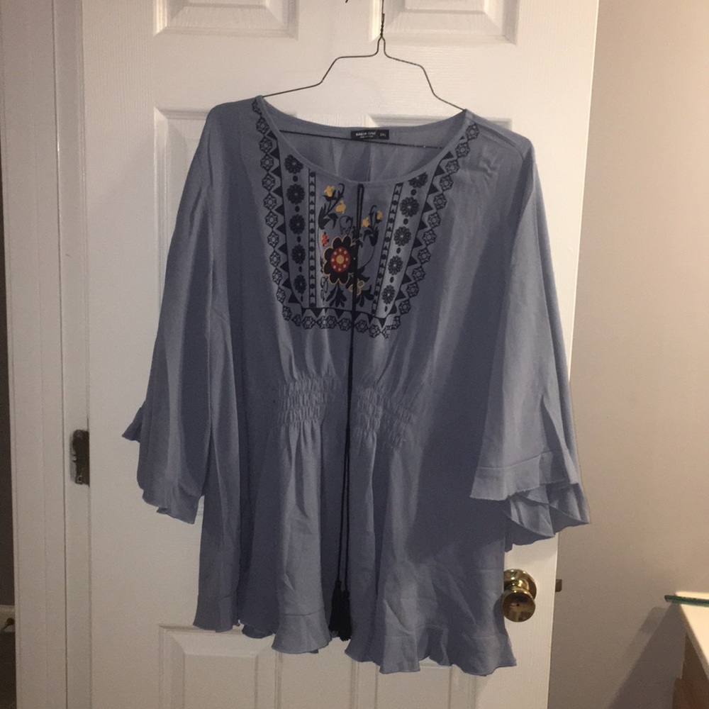 Light blue top with floral design on the front.